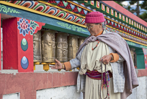 Devotee spinning prayer wheels